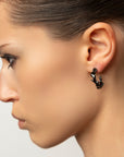 Mystic black stud earrings, sterling silver, rhodium plated, irregular shape,
second close-up