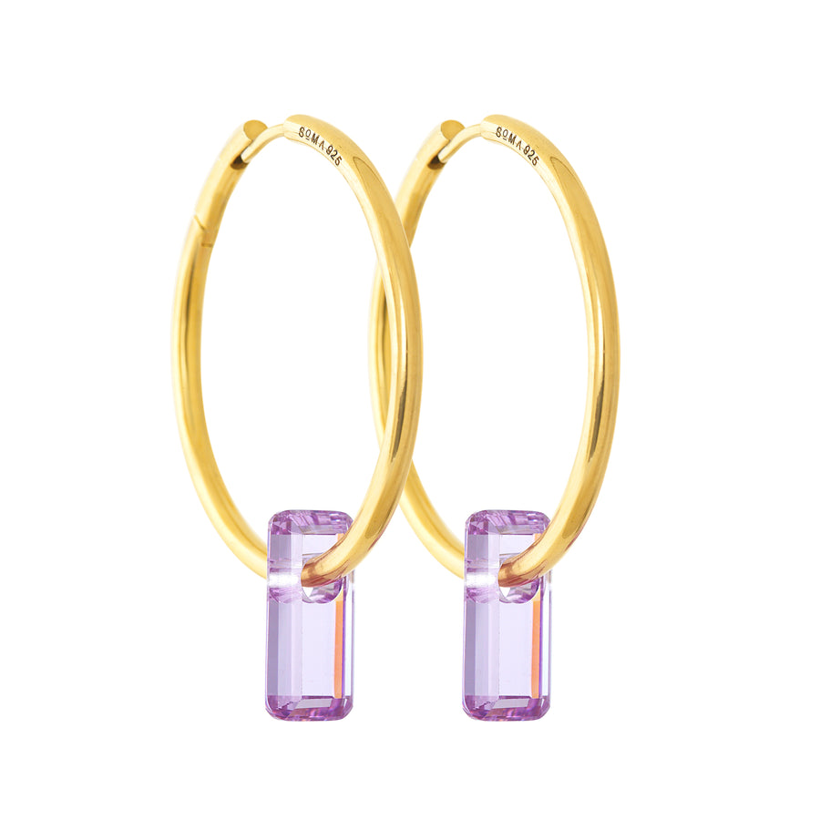 golden earrings, large hoops, stone trough hoops, white background.