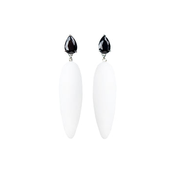 white rubber, large earrings , drop shaped black stone, white background.