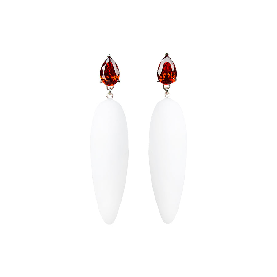 white rubber, large earrings , drop shaped red stone, white background.
