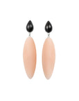 beige rubber, large earrings , tear shaped rosewood, white background.