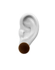 porcelain ear,  brown velvet earring, on top, white background.