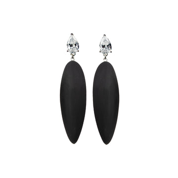 black rubber, large earrings , drop shaped white stone, white background.