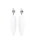 white rubber, large earrings , drop shaped white stone, white background.